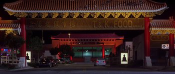 Movie still from “The Fast and the Furious” (2001), directed by Rob Cohen – A car parked in front of an asian restaurant at night; Extreme Wide shot, High angle