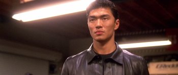 Movie still from “The Fast and the Furious” (2001), directed by Rob Cohen – A man in a black leather jacket looking at the camera; Close Up shot, Low angle