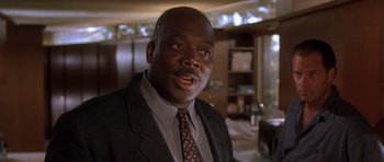 Movie still from “The Fast and the Furious” (2001), directed by Rob Cohen – A man in a suit and tie in front of a mirror; Close Up shot, Low angle