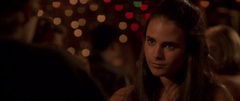 Movie still from “The Fast and the Furious” (2001), directed by Rob Cohen – A beautiful young lady standing next to a bunch of lights; Close Up shot, Over the shoulder angle