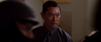 Movie still from “The Fast and the Furious” (2001), directed by Rob Cohen – A person wearing a shirt and a tie; Close Up shot, Over the shoulder angle