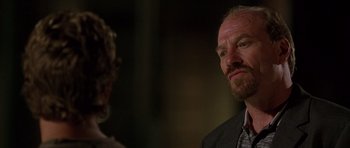 Movie still from “The Fast and the Furious” (2001), directed by Rob Cohen – A man in a suit and tie talking to another man in a suit and tie; Close Up shot, Over the shoulder angle