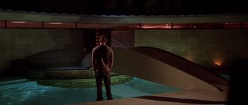 Movie still from “The Fast and the Furious” (2001), directed by Rob Cohen – A man standing in front of a pool at night; Wide shot, Low angle