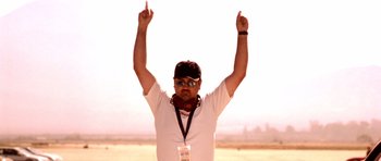 Movie still from “The Fast and the Furious” (2001), directed by Rob Cohen – A man in a white shirt is holding his hands up; Close Up shot, Low angle