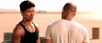 Movie still from “The Fast and the Furious” (2001), directed by Rob Cohen – Two men talking to each other in a field; Close Up shot, Over the shoulder angle