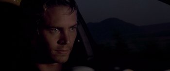 Movie still from “The Fast and the Furious” (2001), directed by Rob Cohen – A person in a car at night; Close Up shot, Over the shoulder angle
