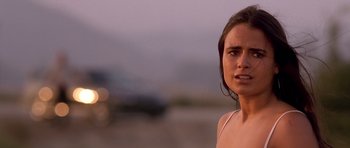 Movie still from “The Fast and the Furious” (2001), directed by Rob Cohen – A woman standing on the side of a road with her mouth open; Close Up shot, Over the shoulder angle