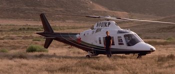 Movie still from “The Fast and the Furious” (2001), directed by Rob Cohen – A man standing in front of a helicopter in a field; Wide shot, Low angle