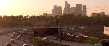 Movie still from “The Fast and the Furious” (2001), directed by Rob Cohen – A view of a freeway and a city skyline at sunset; Extreme Wide shot, Low angle