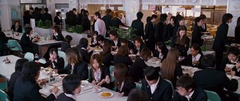 Movie still from “The Fast and the Furious: Tokyo Drift” (2006), directed by Justin Lin – A group of people sitting at a table eating food; Wide shot, High angle