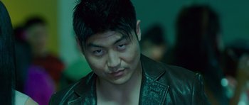Movie still from “The Fast and the Furious: Tokyo Drift” (2006), directed by Justin Lin – A person wearing a leather jacket; Close Up shot, Low angle