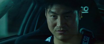 Movie still from “The Fast and the Furious: Tokyo Drift” (2006), directed by Justin Lin – A person in a car looking at the camera; Close Up shot, Low angle
