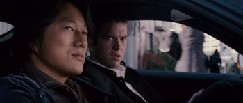 Movie still from “The Fast and the Furious: Tokyo Drift” (2006), directed by Justin Lin – A man and a woman sitting in the back of a car; Close Up shot, Over the shoulder angle
