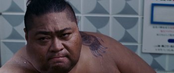 Movie still from “The Fast and the Furious: Tokyo Drift” (2006), directed by Justin Lin – A person with a tattoo on their back; Close Up shot, Low angle
