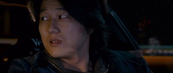 Movie still from “The Fast and the Furious: Tokyo Drift” (2006), directed by Justin Lin – A person wearing a black jacket; Close Up shot, Over the shoulder angle