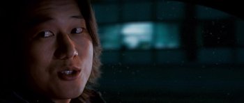 Movie still from “The Fast and the Furious: Tokyo Drift” (2006), directed by Justin Lin – A woman's face in a dark room; Close Up shot, Over the shoulder angle