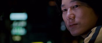 Movie still from “The Fast and the Furious: Tokyo Drift” (2006), directed by Justin Lin – A person's face at night time; Close Up shot, Over the shoulder angle