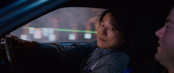 Movie still from “The Fast and the Furious: Tokyo Drift” (2006), directed by Justin Lin – A person sitting in a car at night; Close Up shot, Over the shoulder angle