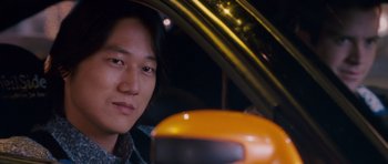 Movie still from “The Fast and the Furious: Tokyo Drift” (2006), directed by Justin Lin – A man sitting in the driver's seat of a car; Close Up shot, Over the shoulder angle