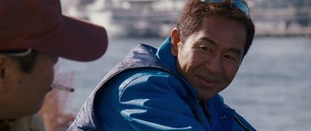 Movie still from “The Fast and the Furious: Tokyo Drift” (2006), directed by Justin Lin – A person wearing a blue jacket; Close Up shot, Over the shoulder angle