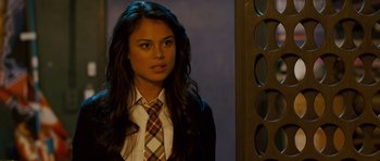 Movie still from “The Fast and the Furious: Tokyo Drift” (2006), directed by Justin Lin – A woman in a suit and tie standing in front of a mirror; Close Up shot, Over the shoulder angle
