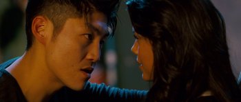 Movie still from “The Fast and the Furious: Tokyo Drift” (2006), directed by Justin Lin – A man and a woman face to face in the dark; Close Up shot, Over the shoulder angle