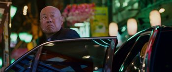 Movie still from “The Fast and the Furious: Tokyo Drift” (2006), directed by Justin Lin – An older man sitting in the back seat of a car; Medium shot, Low angle