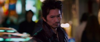 Movie still from “The Fast and the Furious: Tokyo Drift” (2006), directed by Justin Lin – A person wearing a jacket; Close Up shot, Over the shoulder angle