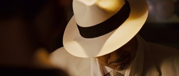 Movie still from “The Fast and the Furious: Tokyo Drift” (2006), directed by Justin Lin – A person wearing a white hat; Extreme Close Up shot, Over the shoulder angle