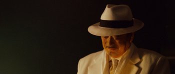 Movie still from “The Fast and the Furious: Tokyo Drift” (2006), directed by Justin Lin – A man wearing a white suit and a hat; Close Up shot, Low angle
