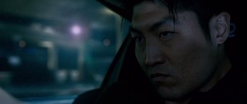 Movie still from “The Fast and the Furious: Tokyo Drift” (2006), directed by Justin Lin – A person in a car looking at the camera; Close Up shot, Low angle