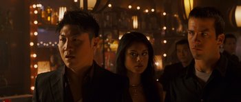 Movie still from “The Fast and the Furious: Tokyo Drift” (2006), directed by Justin Lin – A man and a woman standing next to each other in a bar; Close Up shot, Low angle