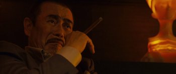 Movie still from “The Fast and the Furious: Tokyo Drift” (2006), directed by Justin Lin – A person holding a cigarette holder; Extreme Close Up shot, Low angle