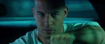 Movie still from “The Fast and the Furious: Tokyo Drift” (2006), directed by Justin Lin – A person with a fist up; Close Up shot, Over the shoulder angle