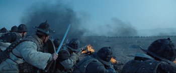 Movie still from “The Fortress” (2017), directed by Hwang Dong-hyuk – A group of men in military uniforms on top of a field; Medium shot, Over the shoulder angle