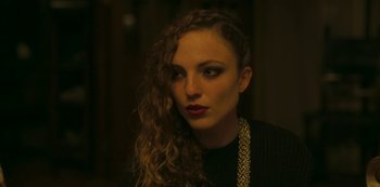 Movie still from “The Girl in the Mirror” (2022), created by Sergio G. Sánchez – A beautiful woman with long curly brown hair; Close Up shot, High angle