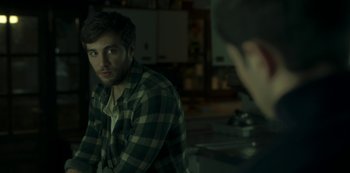Movie still from “The Girl in the Mirror” (2022), created by Sergio G. Sánchez – A man in a plaid shirt is sitting in front of a mirror; Close Up shot, Over the shoulder angle