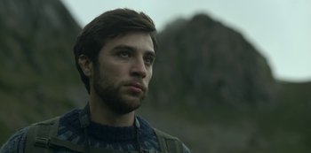 Movie still from “The Girl in the Mirror” (2022), created by Sergio G. Sánchez – A person with a beard looking to his left; Close Up shot, Low angle