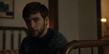 Movie still from “The Girl in the Mirror” (2022), created by Sergio G. Sánchez – A man with a beard is sitting in a chair; Close Up shot, Over the shoulder angle