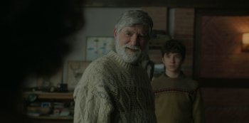 Movie still from “The Girl in the Mirror” (2022), created by Sergio G. Sánchez – An older man wearing a sweater and a young man wearing a sweater; Medium shot, Over the shoulder angle