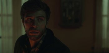 Movie still from “The Girl in the Mirror” (2022), created by Sergio G. Sánchez – A person in a dark room; Close Up shot, Over the shoulder angle