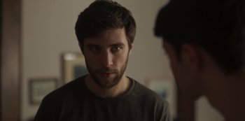 Movie still from “The Girl in the Mirror” (2022), created by Sergio G. Sánchez – A man with a beard looking at himself in the mirror; Close Up shot, Over the shoulder angle