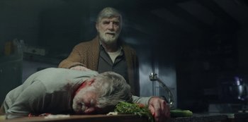 Movie still from “The Girl in the Mirror” (2022), created by Sergio G. Sánchez – An old man standing next to a dead man; Medium shot, Over the shoulder angle