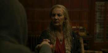 Movie still from “The Girl in the Mirror” (2022), created by Sergio G. Sánchez – An older woman is looking at a man in a suit; Close Up shot, Over the shoulder angle