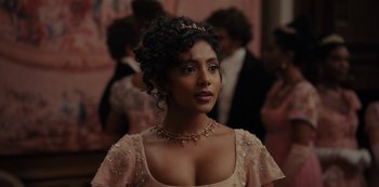 Movie still from “Bridgerton” (2020), created by Chris Van Dusen – A woman in a pink dress and a tiara; Close Up shot, Over the shoulder angle