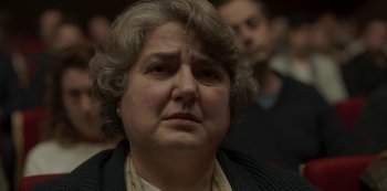 Movie still from “The Girl in the Mirror” (2022), created by Sergio G. Sánchez – An older woman is looking at the camera; Close Up shot, Low angle