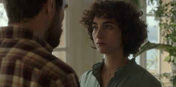 Movie still from “The Girl in the Mirror” (2022), created by Sergio G. Sánchez – A man and a woman looking at one another; Close Up shot, Over the shoulder angle