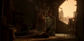 Movie still from “The Girl in the Mirror” (2022), created by Sergio G. Sánchez – Two women sitting on the ground in a room; Wide shot, Over the shoulder angle