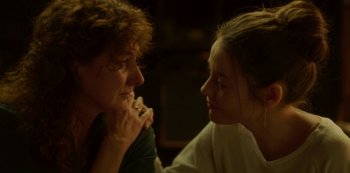 Movie still from “The Girl in the Mirror” (2022), created by Sergio G. Sánchez – Two people are looking at each other in the dark; Close Up shot, Over the shoulder angle