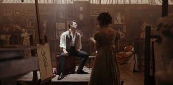 Movie still from “Bridgerton” (2020), created by Chris Van Dusen – A man and a woman are in a painting studio; Medium shot, Over the shoulder angle